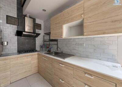 Modern kitchen with wooden cabinets and stainless steel appliances