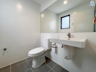 Modern bathroom with white fixtures and gray tiles