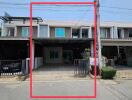 Front view of a modern townhouse with carport