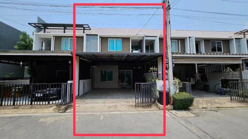 Front view of a modern townhouse with carport