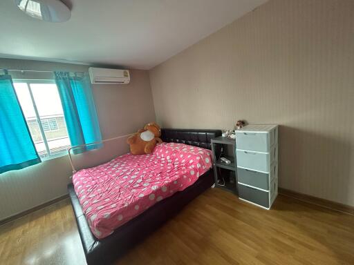 Cozy bedroom with pink bedding and ample natural light