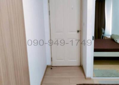 Interior view of a clean and well-maintained hallway leading to a bedroom