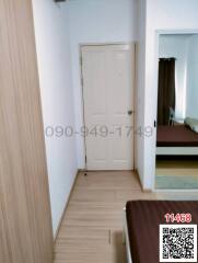 Interior view of a clean and well-maintained hallway leading to a bedroom