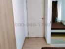 Interior view of a clean and well-maintained hallway leading to a bedroom