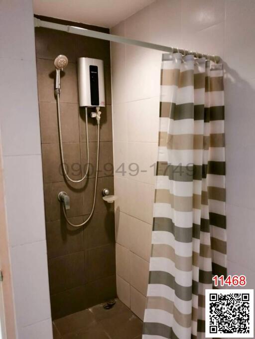 Modern bathroom with wall-mounted shower and curtain