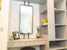 Modern bedroom with stylish vanity area including a large mirror and wooden shelves