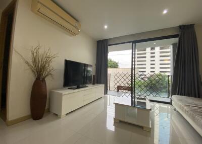 Spacious and modern living room with large windows and outdoor view