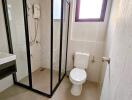 Modern bathroom with shower enclosure and white ceramic fixtures