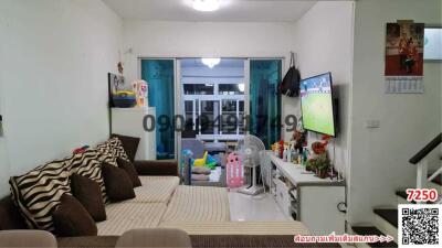 Spacious and well-lit living room with modern amenities and balcony access