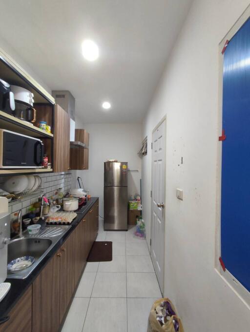 Long narrow kitchen with modern appliances and ample storage space