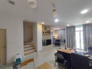 Spacious and modern living room with stair access and balcony