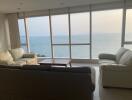 Spacious living room with large windows offering panoramic sea views