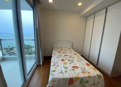 Bright bedroom with ocean view and large windows