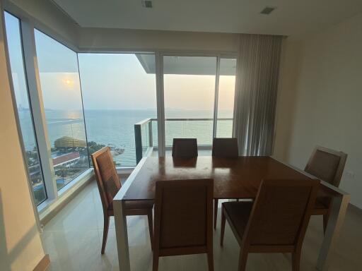 Spacious dining room with large windows overlooking the sea