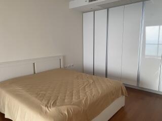 Spacious bedroom with large bed and extensive wardrobe
