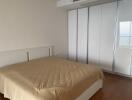 Spacious bedroom with large bed and extensive wardrobe