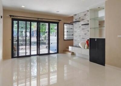 Spacious and modern living room with large sliding doors and stylish built-in shelves