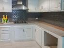 Modern kitchen with white cabinets and blue backsplash