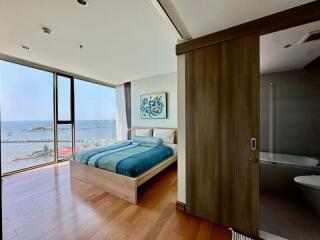Ocean view bedroom with large window and modern design