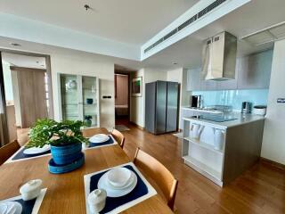 Modern kitchen with dining area featuring wooden floors and contemporary appliances