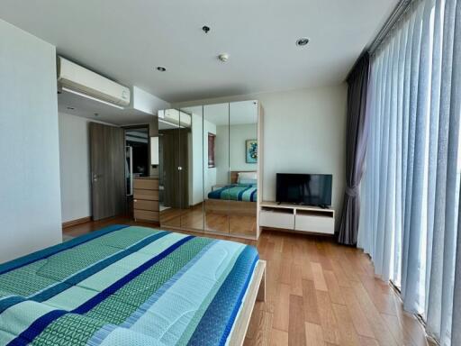 Spacious bedroom with modern furnishings and ample natural light