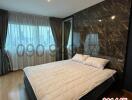 Spacious bedroom with luxurious marble wall and large windows