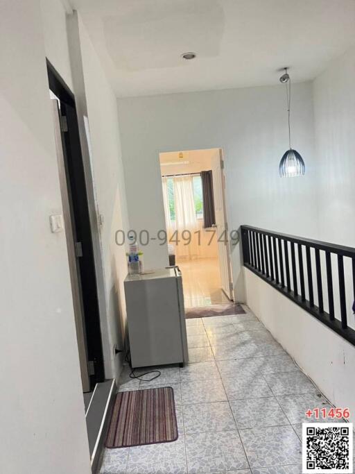 Bright and spacious hallway leading to a room with natural light