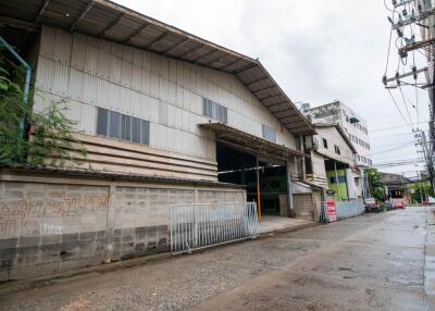 Exterior view of a large industrial building with street in front