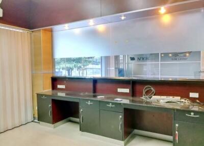 Spacious modern kitchen with extended counter space and glass window