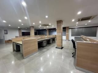 Spacious modern office with multiple workstations and ample lighting