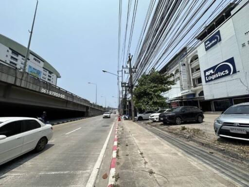 Street view outside a building with road and parked cars