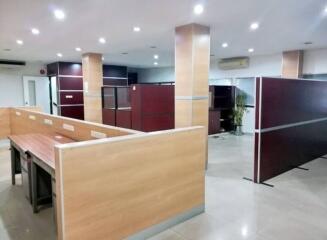 Spacious modern office interior with partitioned cubicles and ambient lighting