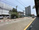 Urban street view with residential high-rise building and commercial shops