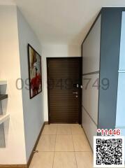 Modern entryway with wooden door and decorative artwork