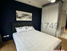 Modern bedroom with dark blue wall and stylish decor