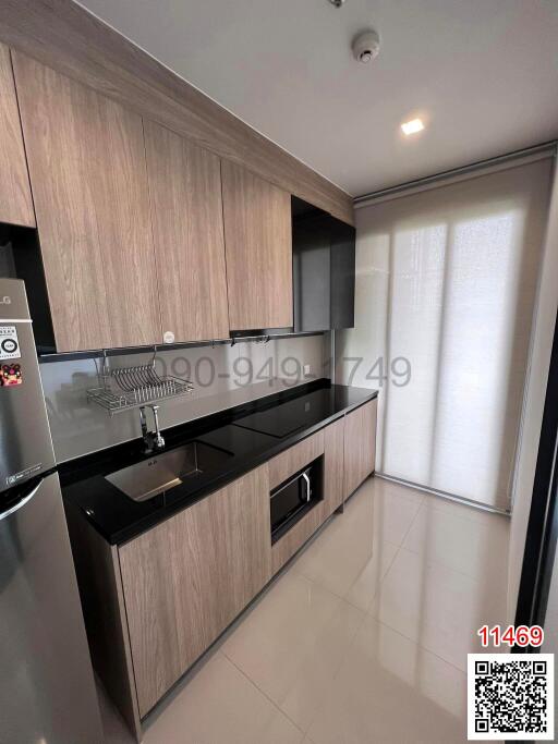 Modern kitchen with wooden cabinets and black countertops