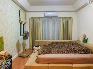 Cozy bedroom with beige walls and ample natural light