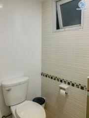 Compact bathroom with white and striped tiles