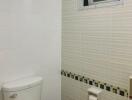 Compact bathroom with white and striped tiles