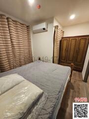 Cozy bedroom with wooden wardrobe and modern air conditioning