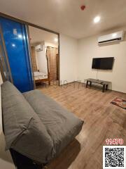 Modern bedroom with wooden flooring, comfortable bed, and wall-mounted TV