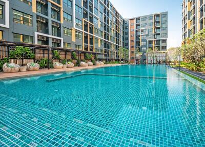 Luxurious outdoor swimming pool with residential buildings in the background