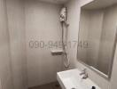 Modern bathroom with bathtub and wall-mounted shower
