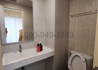 Modern bathroom with neutral tiles and essential fixtures