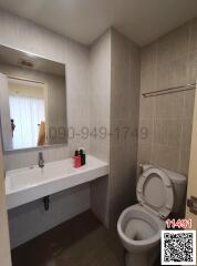 Modern bathroom with neutral tiles and essential fixtures