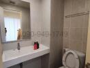 Modern bathroom with neutral tiles and essential fixtures