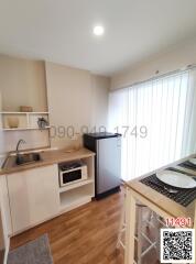 Compact modern kitchen with white cabinetry and essential appliances