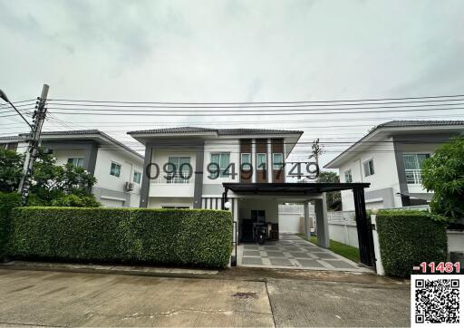 Modern two-story residential home with a gated entry