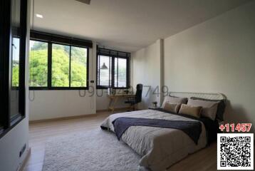 Spacious bedroom with a large window and scenic view