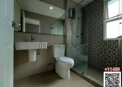 Modern bathroom with shower and neutral tiles